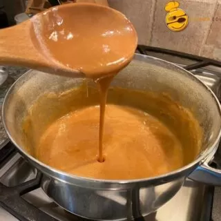 Homemade Mexican Cajeta dripping from a spoon