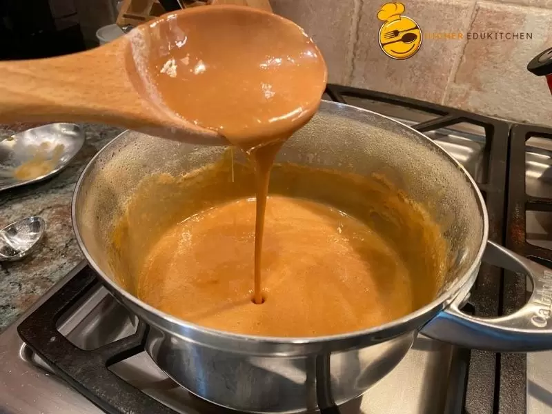 Homemade Mexican Cajeta dripping from a spoon