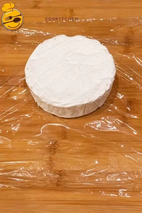 Wrapping the brie cheese in plastic food wrap